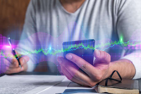 Multi exposure of man signing contract with phone and forex chart hologram. Concept of financial...