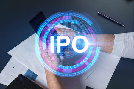 Man using phone. Hands typing smartphone. Double exposure with ipo hologram. Close up. Financial graph and analysis concept. Investment.の写真素材