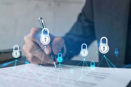 Businessman in suit signs contract. Double exposure with lock icon hologram. Man signing agreement...