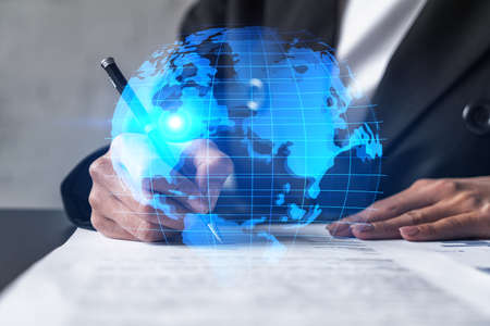 World map and a woman signing papers. Double exposure.