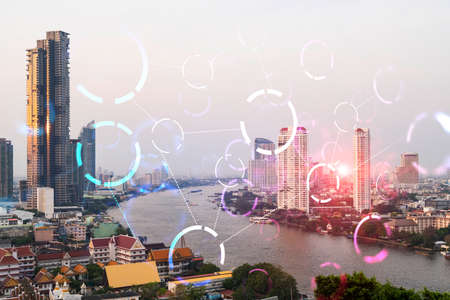 Abstract technology icons hologram over panorama city view of Bangkok, Asia. The concept of people networking and connections. Double exposure.の写真素材