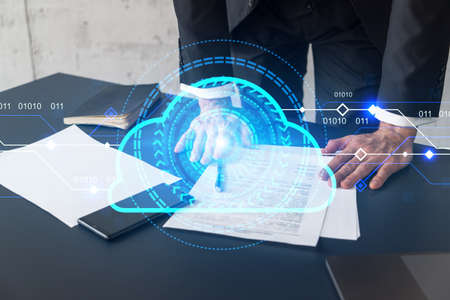 Businessman in suit signs contract. Double exposure with cloud icon hologram. Partnership in it...