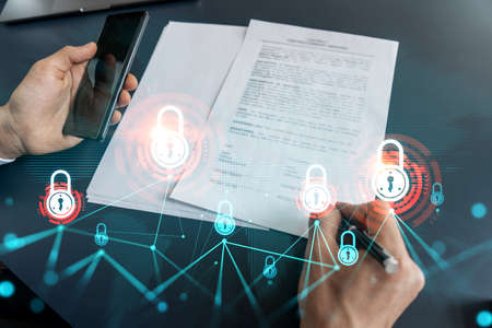 Businessman is signing a contract and lock drawing. Concept of new partnership in real life and safe business data. double exposureの写真素材