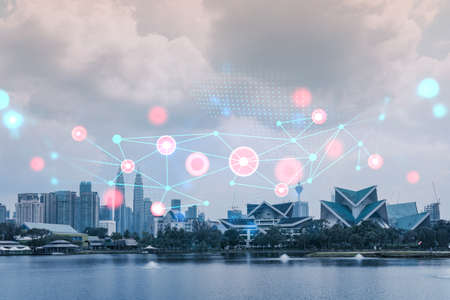 Abstract technology icons hologram over panorama city view of Kuala Lumpur, Malaysia, Asia. The...