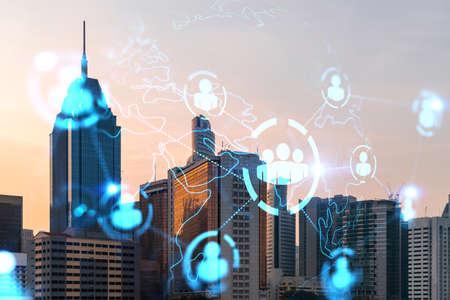 Hologram of social media icons over sunset panoramic cityscape of Kuala Lumpur, Malaysia, Asia. The...