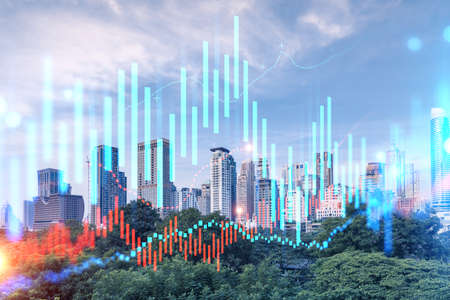 Forex and stock market chart hologram over panorama city view of Bangkok, the financial center in...