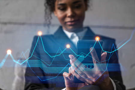 Businesswoman typing phone, work in modern office on new project. Financial graph hologram. Double...