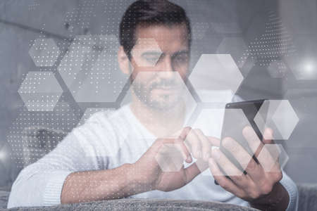 Double exposure. Abstract technology theme drawing hologram. A man typing mobile phone.