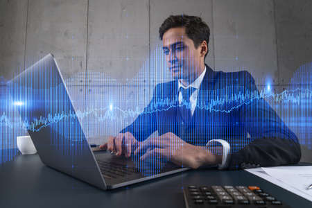 Businessman in office working with laptop technology forex online trading graph and chart, typing...