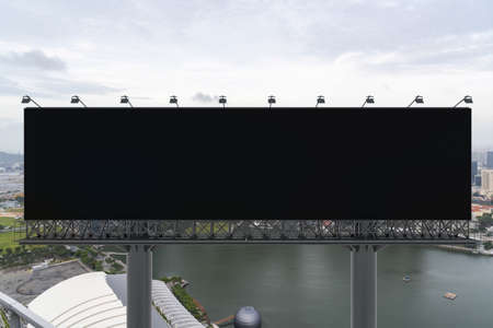 Blank black road billboard with Singapore cityscape background at day time. Street advertising...