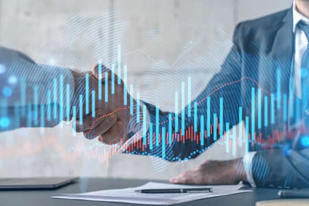 Multiexposure of two businesspeople handshake and forex graph hologram drawing background. Concept...
