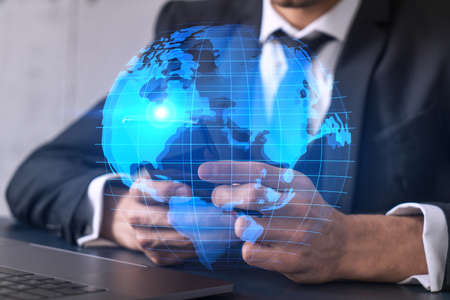 Businessman using phone. World map hologram. Multiexposure. International business concept.