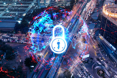 Padlock icon hologram on aerial view of road, busy urban traffic highway at night. Junction network of transportation infrastructure. The concept of success in cyber security intelligence.の写真素材