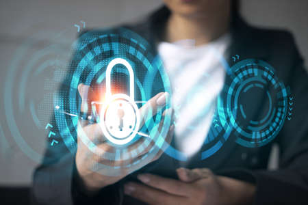 Businesswoman using smart phone in office. Lock icon hologram. Data protection concept. Double exposure.の写真素材