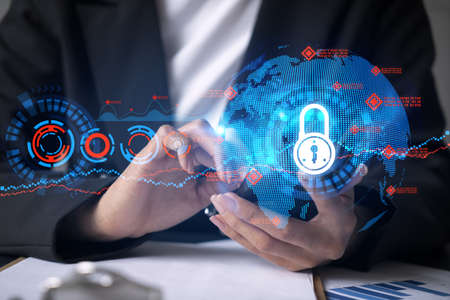 Businesswoman using smart phone in office. Lock icon hologram. Data protection concept. Double exposure.の写真素材