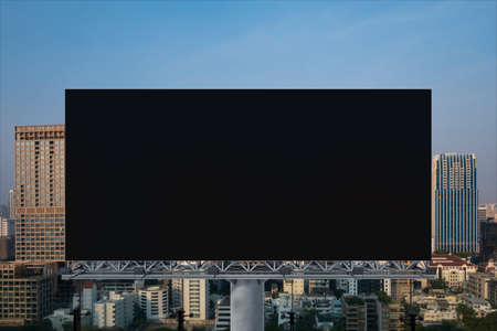 Blank black road billboard with Bangkok cityscape background at sunset. Street advertising poster,...