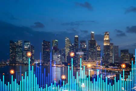 Stock market graph hologram, night panorama city view of Singapore, popular location to gain financial education in Asia. The concept of international research. Double exposure.の写真素材