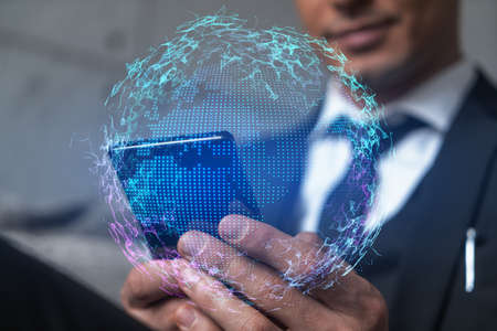 Man in office working with Smartphone, Searching for new countries to work with. International world map hologram, typing phone. Double exposure.の写真素材