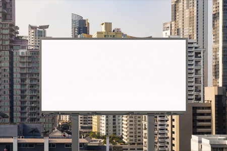 Blank white road billboard with Bangkok cityscape background at day time. Street advertising poster, mock up, 3D rendering. Front view. The concept of marketing communication to promote or sell idea.の写真素材
