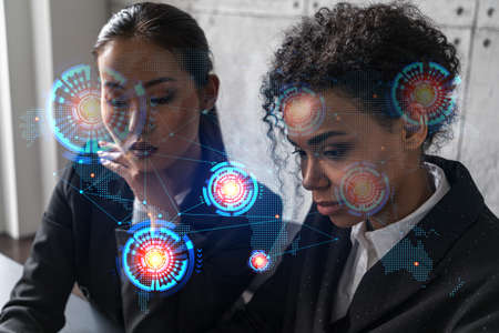 Two businesswomen work together in modern office on new project. Double exposure. Concept of...