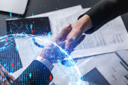 Multiexposure of two businesspeople handshake and social media network icon hologram drawing...