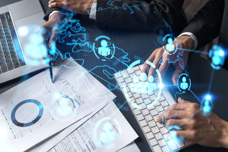 Man and woman working together on social media project. Blue infographic of people network hologram....