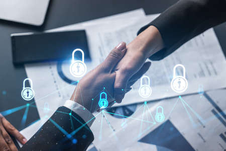 Multiexposure of two businesspeople handshake and lock icon hologram drawing background. Concept of...