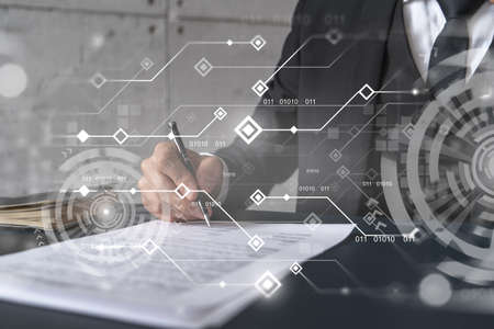 Businessman in suit signs contract. Double exposure with technology illustration hologram. New...