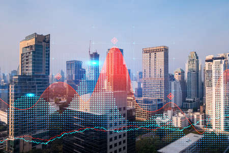 Glowing FOREX graph hologram, aerial panoramic cityscape of Bangkok at sunset. Stock and bond trading in Asia. The concept of fund management. Double exposure.の写真素材