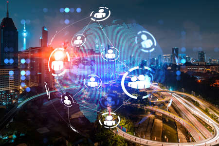 Glowing Social media icons on night panoramic city view of Kuala Lumpur, Malaysia, Asia. The concept of networking and connections between people and businesses in KL. Double exposure.の写真素材