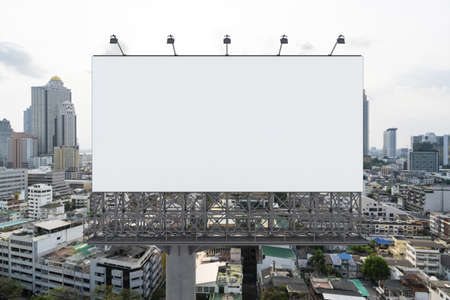 Blank white road billboard with Bangkok cityscape background at day time. Street advertising poster,...