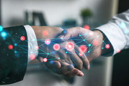 Double exposure of two businesspeople handshake and abstract technology hologram drawing background. Concept of high tech business. Formal wear.の写真素材