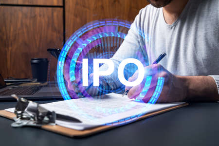 Double exposure of man signing contract with phone and ipo hologram. Concept of initial primary...