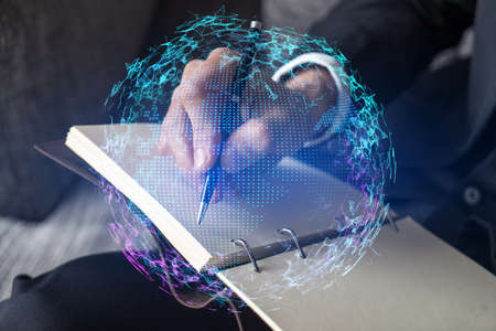 Businessman takes notes background and world map hologram.の写真素材