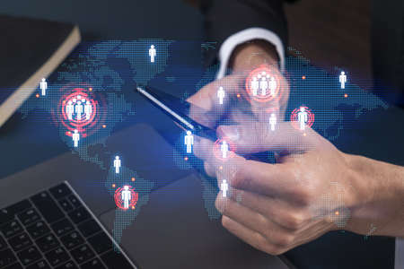 Businessman using phone. World map hologram. Multiexposure. International business concept.の写真素材