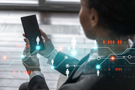 Businesswoman using phone, work in modern office on new project. Double exposure. Concept of success. Social network hologram.の写真素材