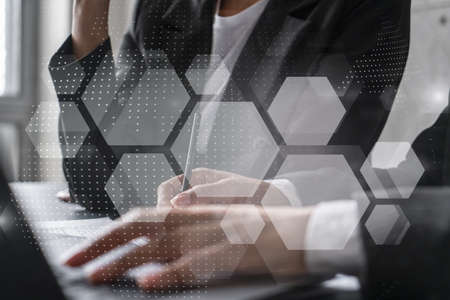 Two businesswomen working together in office. Abstract tech icons holographic illustration double...