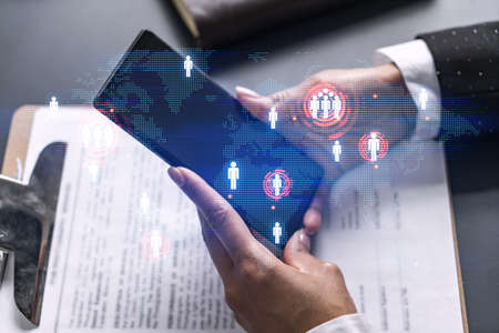 Businesswoman using smart phone in office. International business affairs with world map. Double...