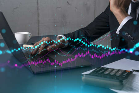 Businessman trading on-line, typing laptop background and forex graph hologram.
