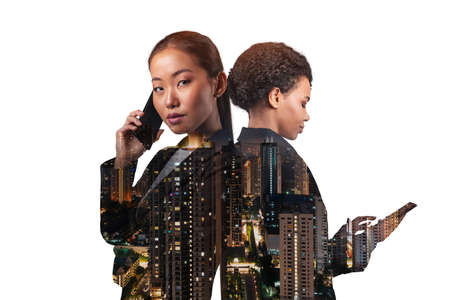 Double exposure of two young, successful, business people, woman, standing in front of Asian city Kuala Lumpur background. Concept of teamwork. Night time.の写真素材