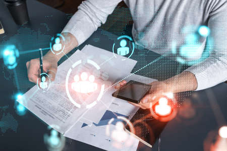 Double exposure of man signing contract with phone and social network icon hologram. Concept of international business of data and information.の写真素材