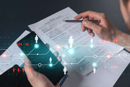 Double exposure of man signing contract with phone and social network icon hologram. Concept of...