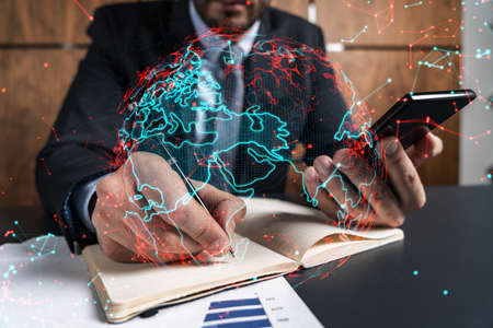 Man office takes notes use phone map world concept. Double exposure.