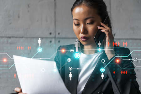 Businesswoman speaks phone and social network hologram. Double exposure.の写真素材