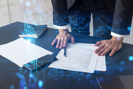 Businessman in suit signs contract. Double exposure with technology illustration hologram. New...