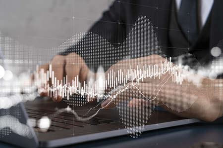 Businessman trading on-line, typing laptop background and forex graph hologram.の写真素材