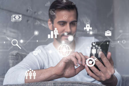 A man typing mobile phone. Double exposure. business research symbol hologram.の写真素材