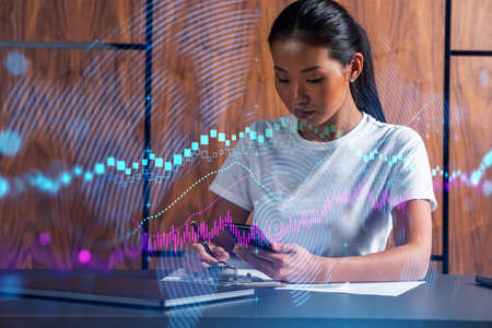 Woman takes notes with phone. Forex graph and chart online trade concept hologram. Multiexposure.