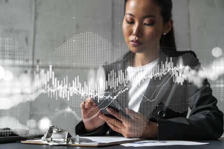 Businesswoman typing phone, work in modern office on new project. forex graph hologram. Double...