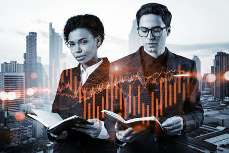 Two colleagues in multinational corporate team working on forecasting trading corporate strategy at...